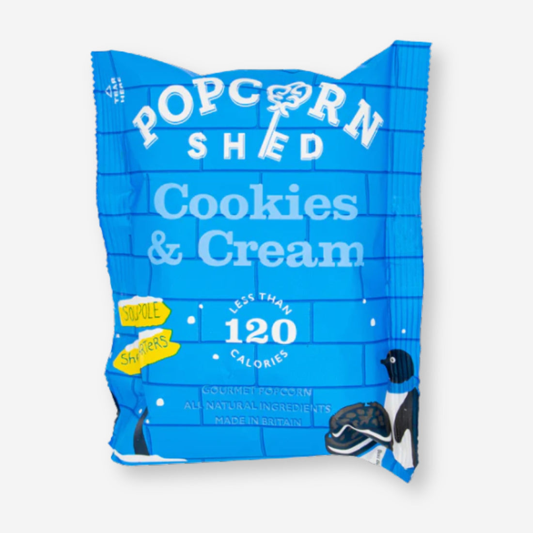 Cookies &amp; Cream Popcorn in a blue bag, showcasing white chocolate caramel popcorn with cookie crumb pieces, highlighting its vegan and all-natural attributes.