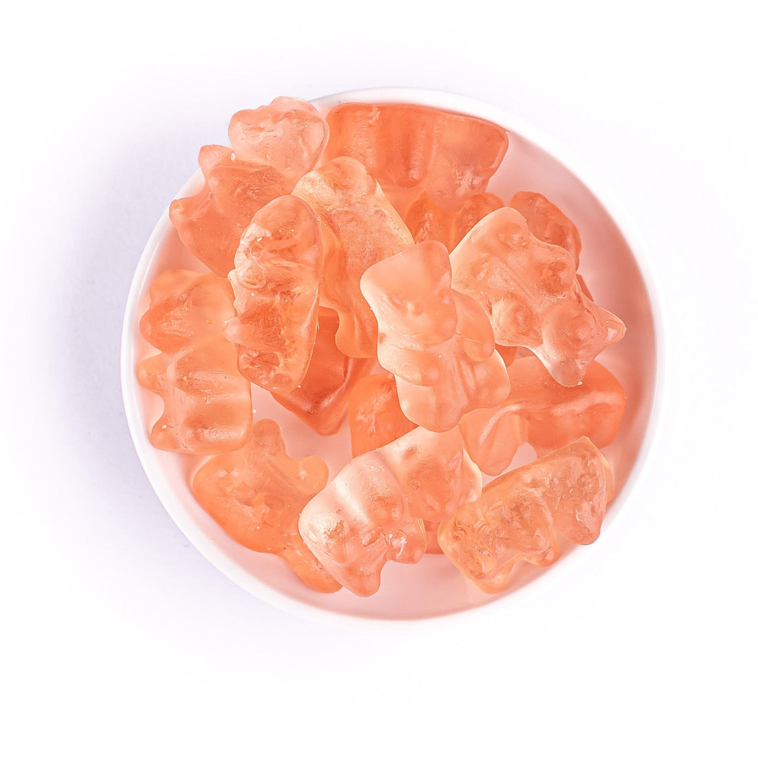 Prosecco Rose Gummies - Non Alcoholic: A bowl of flower-shaped gummies infused with fruity notes of strawberries, cherries, and raspberry.
