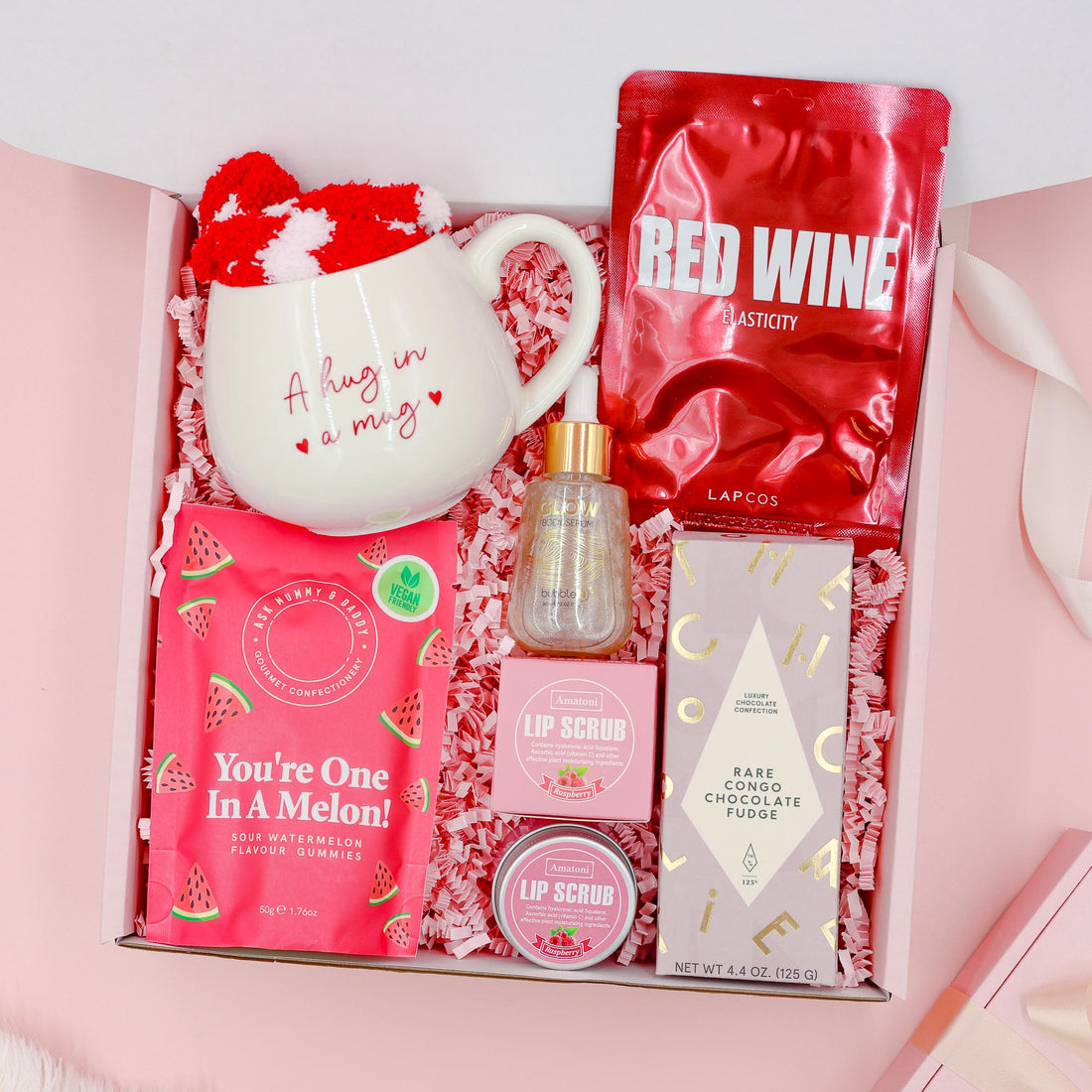 Red Velvet Treats exclusive luxury gift for her with premium chocolate, red wine face mask, Hug in a Mug cup, cosy socks, gummies and lip scrubs.