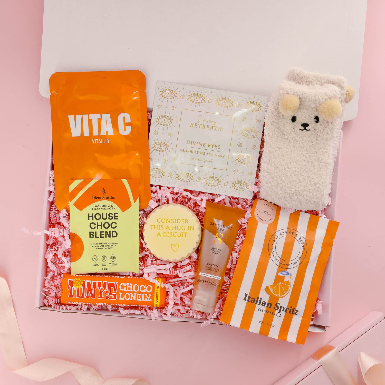 Rest and relax self care gift box for her with bath scrub, eye mask, gourmet chocolate, fluffy socks, hot chocolate, and sweet treats – perfect pamper gift.
