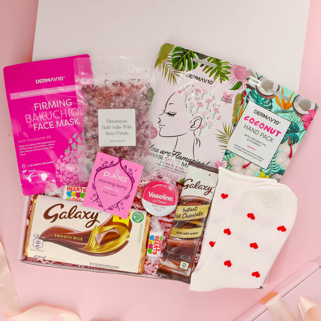 Luxury gift for her with bath salts, firming face mask, Galaxy chocolate, herbal tea, pamper socks, coconut hand mask, and more – self care in a box.