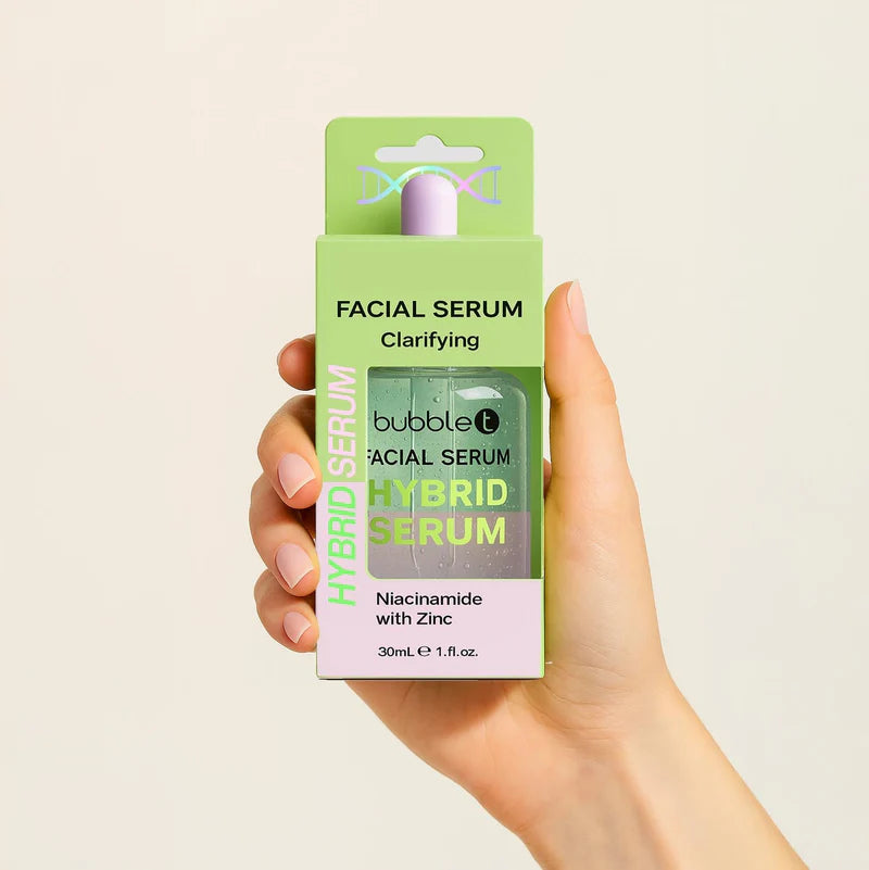 Bubble T Clarifying Facial Serum with niacinamide and zinc; a hand uses a dropper, emphasizing its lightweight, skin-brightening formula alongside its packaging.