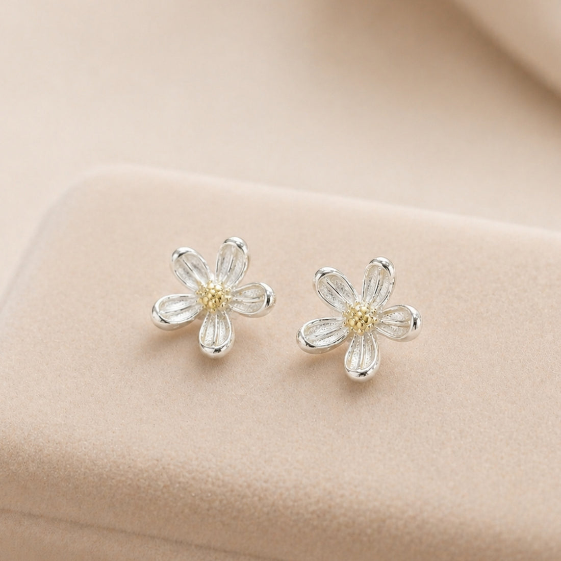 Silver Daisy Stud Earrings with delicate flower design, featuring sterling silver petals and a yellow center, perfect for adding whimsy to any outfit.