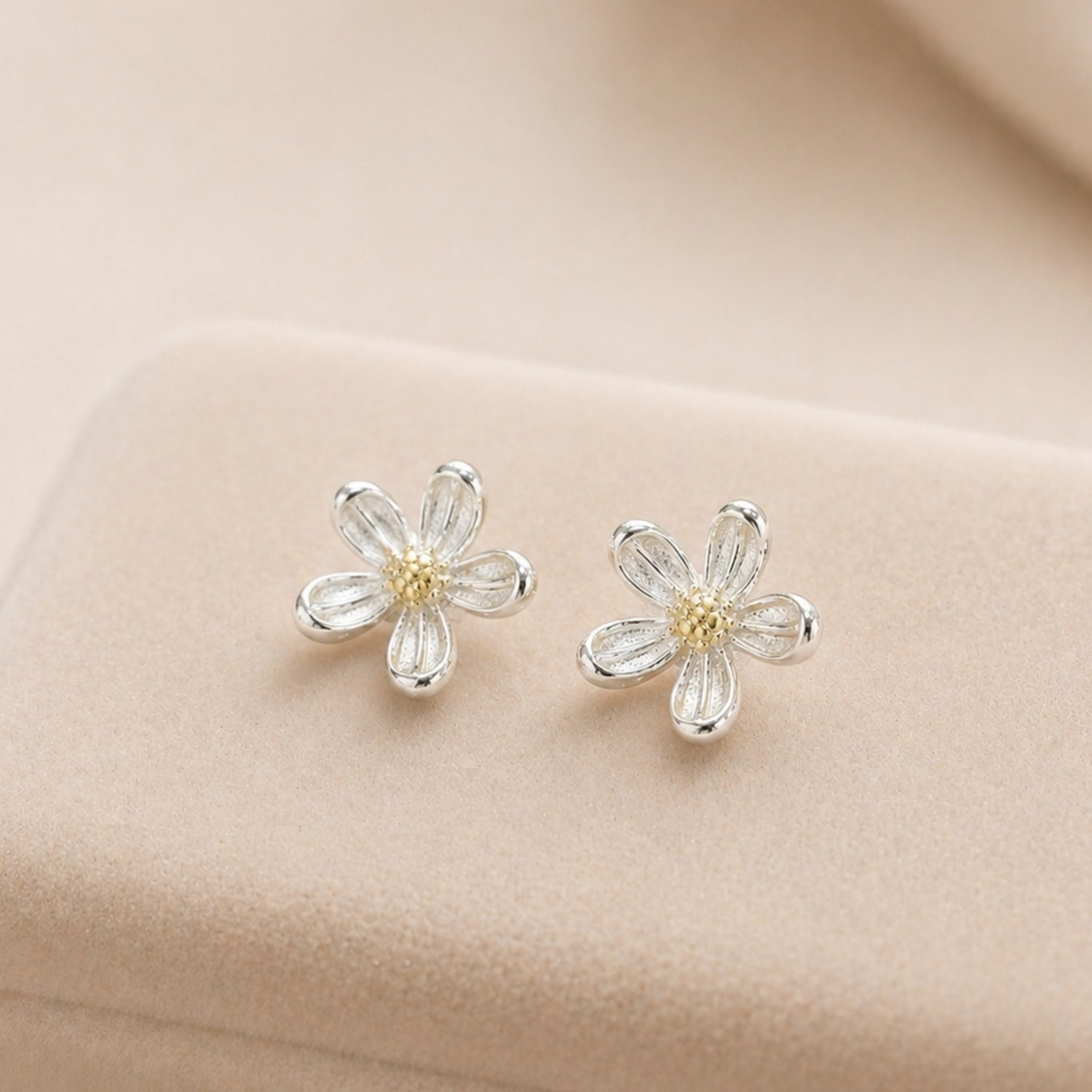 Silver Daisy Stud Earrings with delicate flower design, featuring sterling silver petals and a yellow center, perfect for adding whimsy to any outfit.