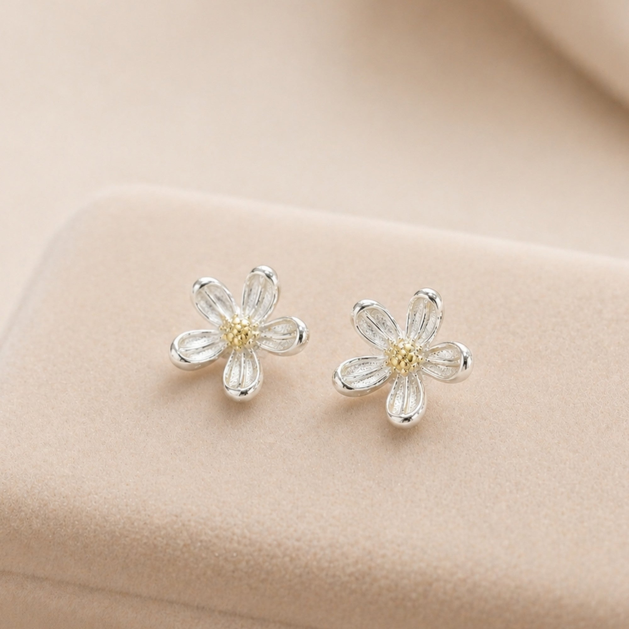 Silver Daisy Stud Earrings with delicate flower design, featuring sterling silver petals and a yellow center, perfect for adding whimsy to any outfit.