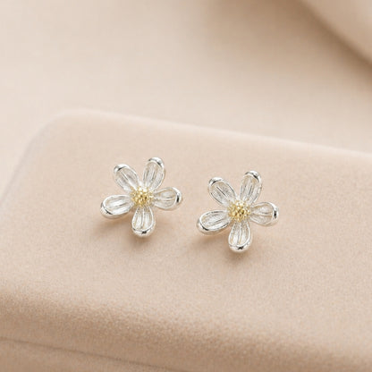 Silver Daisy Stud Earrings with delicate flower design, featuring sterling silver petals and a yellow center, perfect for adding whimsy to any outfit.