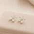 Silver Daisy Stud Earrings with delicate flower design, featuring sterling silver petals and a yellow center, perfect for adding whimsy to any outfit.