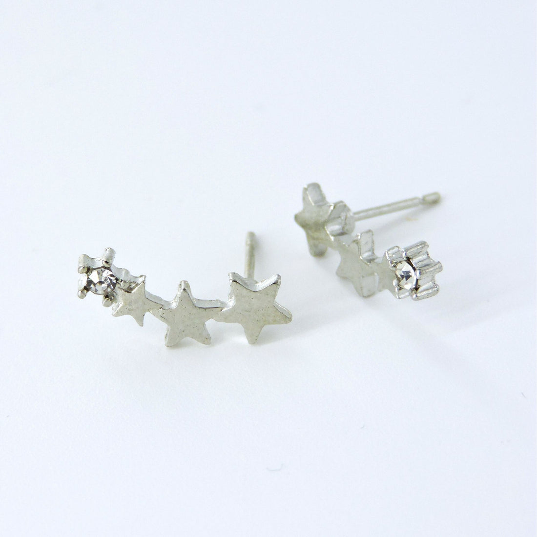 Silver Star Earrings - Celestial Beauty: Close-up of star-shaped earrings with a silver design, offering a playful sparkle and celestial-inspired elegance.