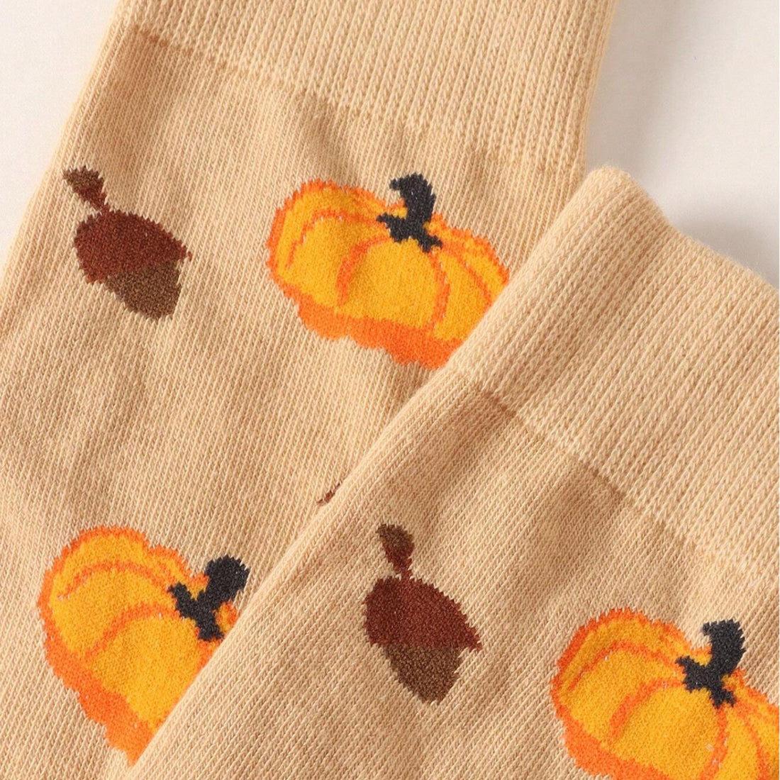 Pumpkin Socks featuring knitted pumpkins and acorns, showcasing intricate stitch patterns. Perfect for embracing autumn&