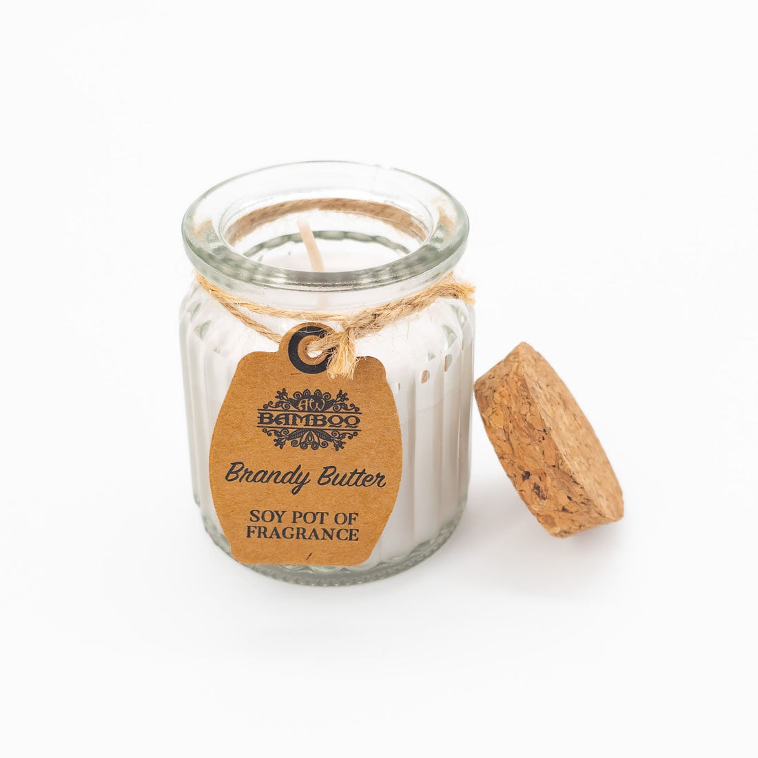 Brandy Butter Soy Pot Candle in a glass jar with cork lid, natural label, and jute twine, offering a cozy 20-hour burn time.