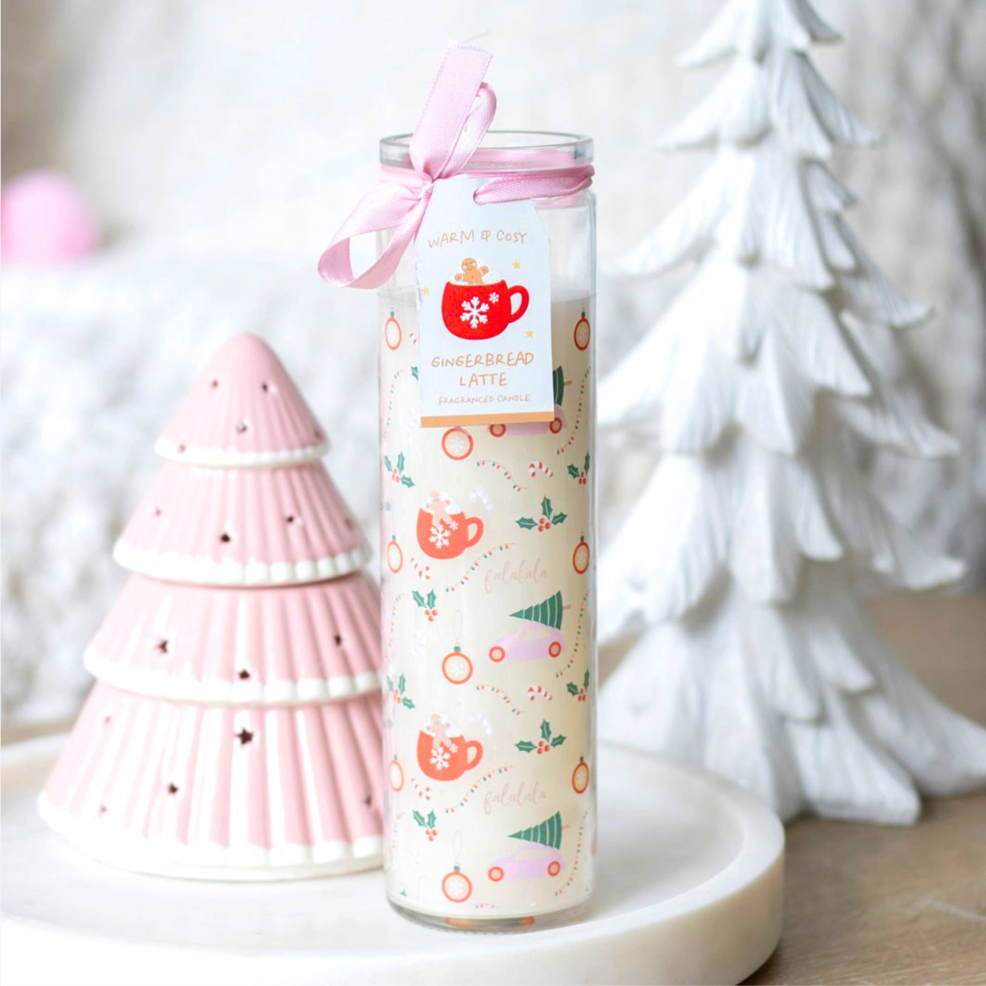 Sugarplum Christmas Print Tube Candle in a decorative jar with a pink ribbon, offering a gingerbread latte scent and 70-hour burn time.