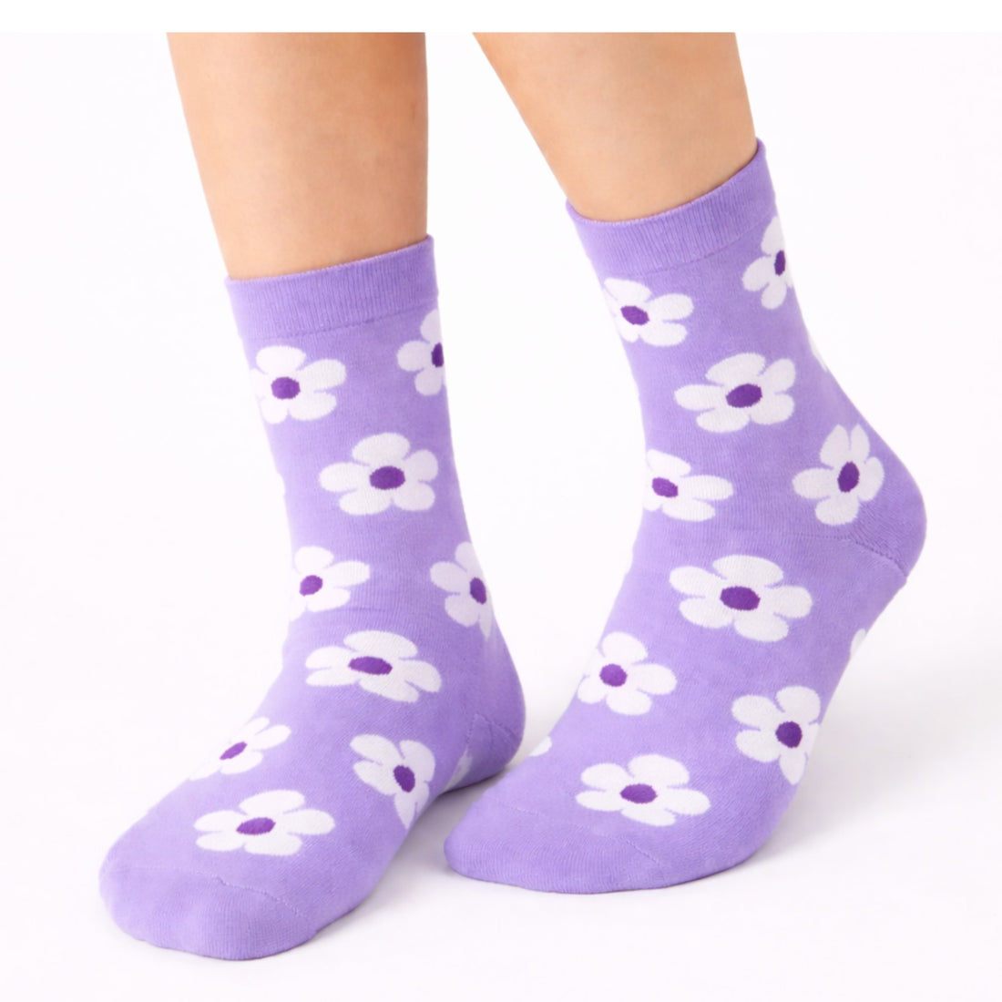 A pair of light purple crew socks featuring a white and dark purple daisy floral pattern, styled with a cream-colored satin ribbon on a minimalist white background. Ideal gift for her