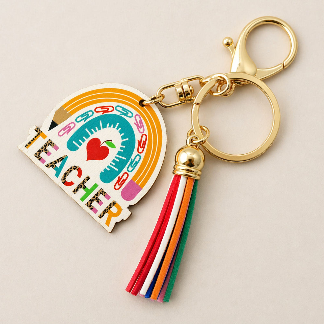 Teacher Keyring featuring a playful design with pencil and apple motifs, ideal for adding charm to keys or bags.