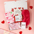 Valentines gift for her featuring pink themed treats, cosy accessories and Valentine’s card