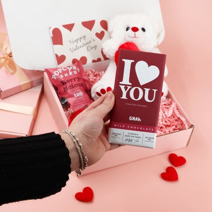 Valentines gift box with chocolate bar, popcorn and romantic Valentine keepsakes
