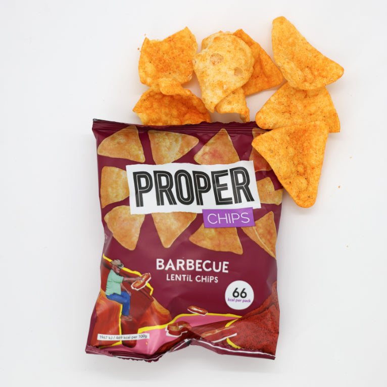 Barbecue Lentil Chips bag, highlighted, held by a man in a hat, showcasing a snack option that&