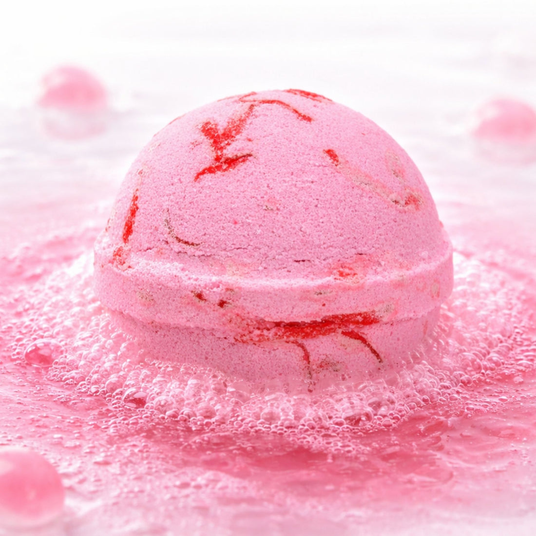 Luxury pink watermelon bath bomb fizzing in water, thoughtful self care gift for her, relaxing pamper treat