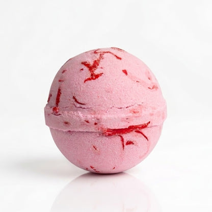 Pink watermelon bath bomb fizzing in bath water, handmade bath fizzer with soft bubbles, pamper gift for her