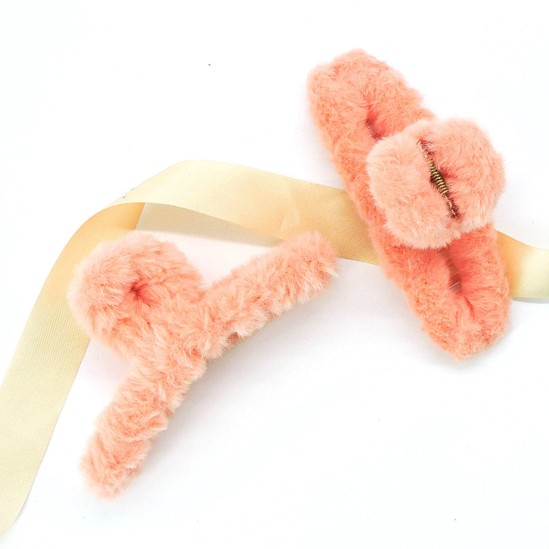 Plush Hair Clip - Peach Pink: A close-up of a fuzzy stuffed animal-inspired hair clip with a spring, designed for comfort and style.