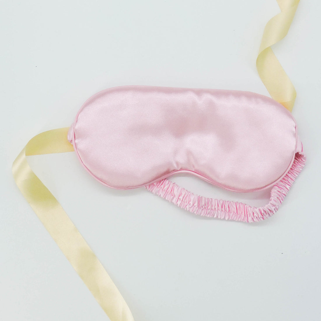 Satin Sleep Mask - Royal Pink, featuring a smooth satin finish with a decorative yellow ribbon, perfect for luxurious, comfortable relaxation and pampering.