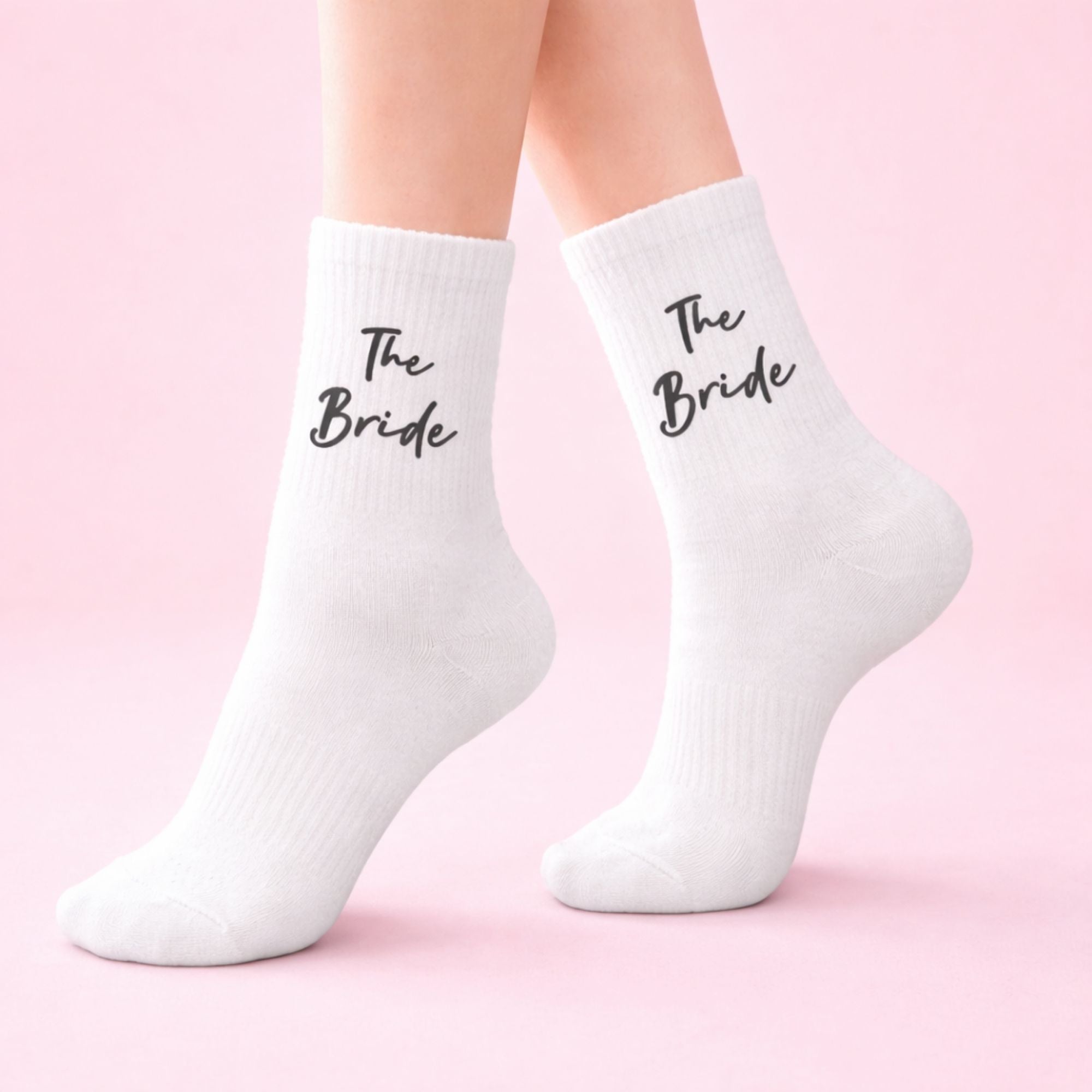 The Bride Socks with black script text, perfect for bridal gifts, featuring elegant design for celebrating the bride-to-be.